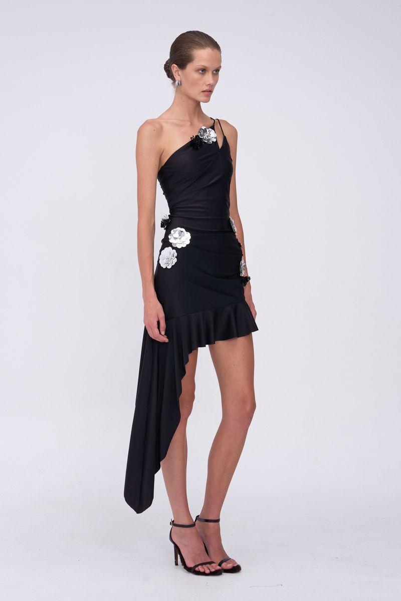Black one-shoulder dress with floral embellishments on a white background