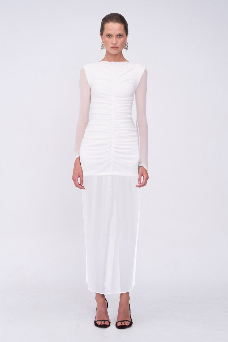 Woman wearing a white dress on a light gray background