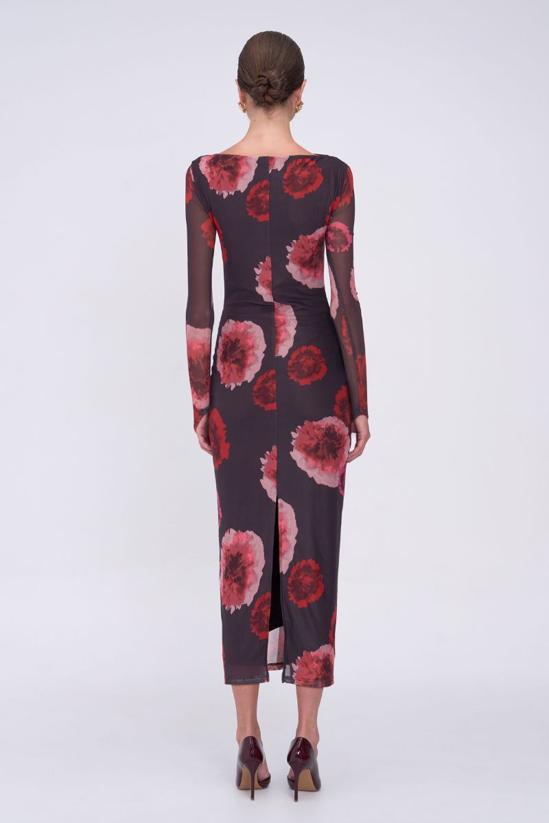 Woman wearing a floral dress with long sleeves on a white background