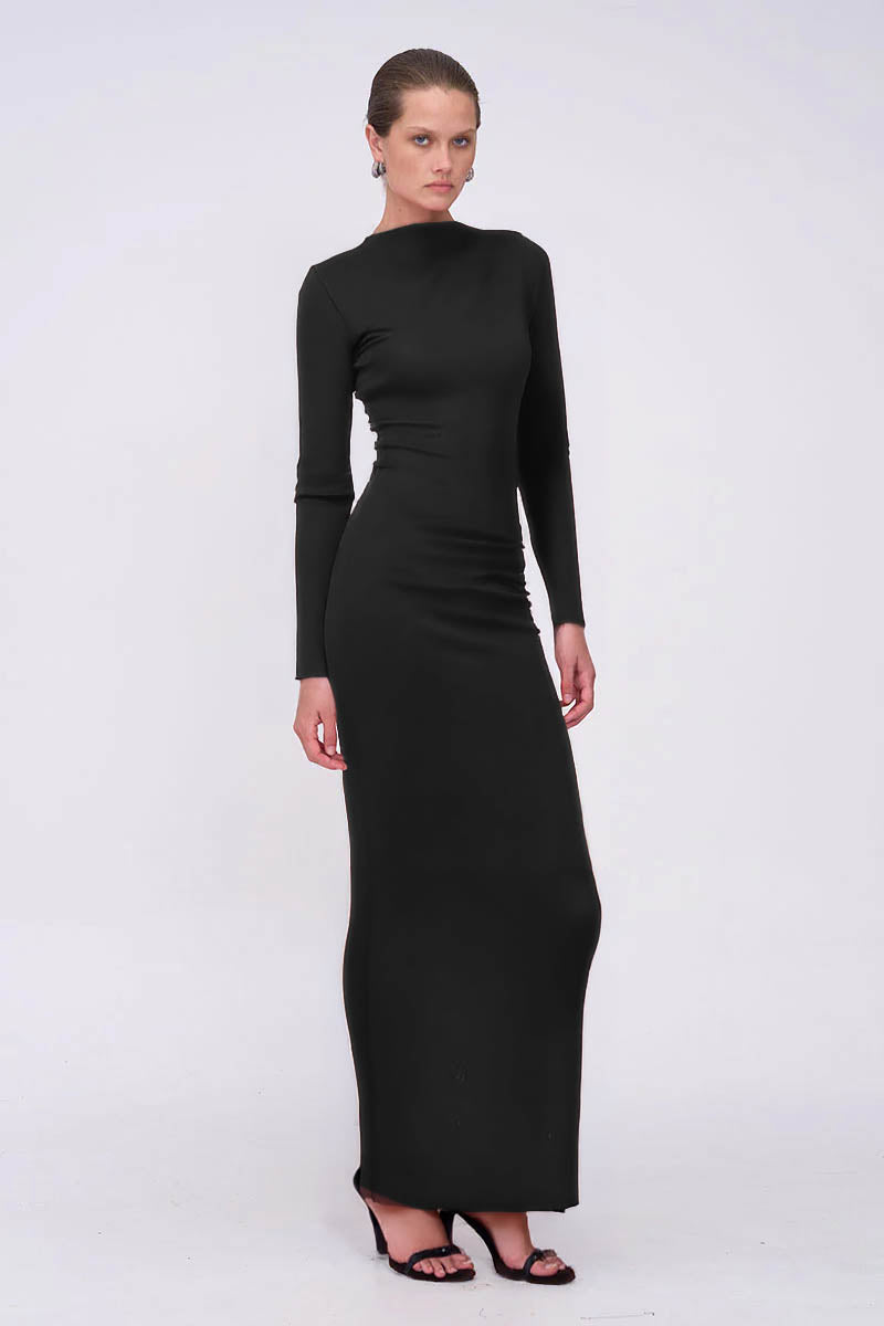 Woman wearing a black long-sleeve dress on a white background