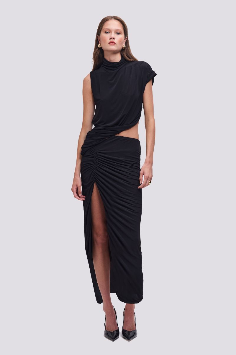 Woman wearing a black outfit with a draped design on a white background