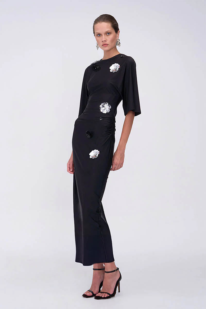 Black dress with floral embellishments on a white background