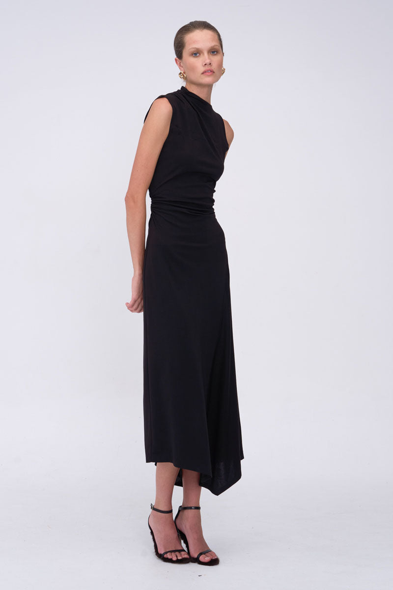 Woman wearing a black sleeveless dress on a white background