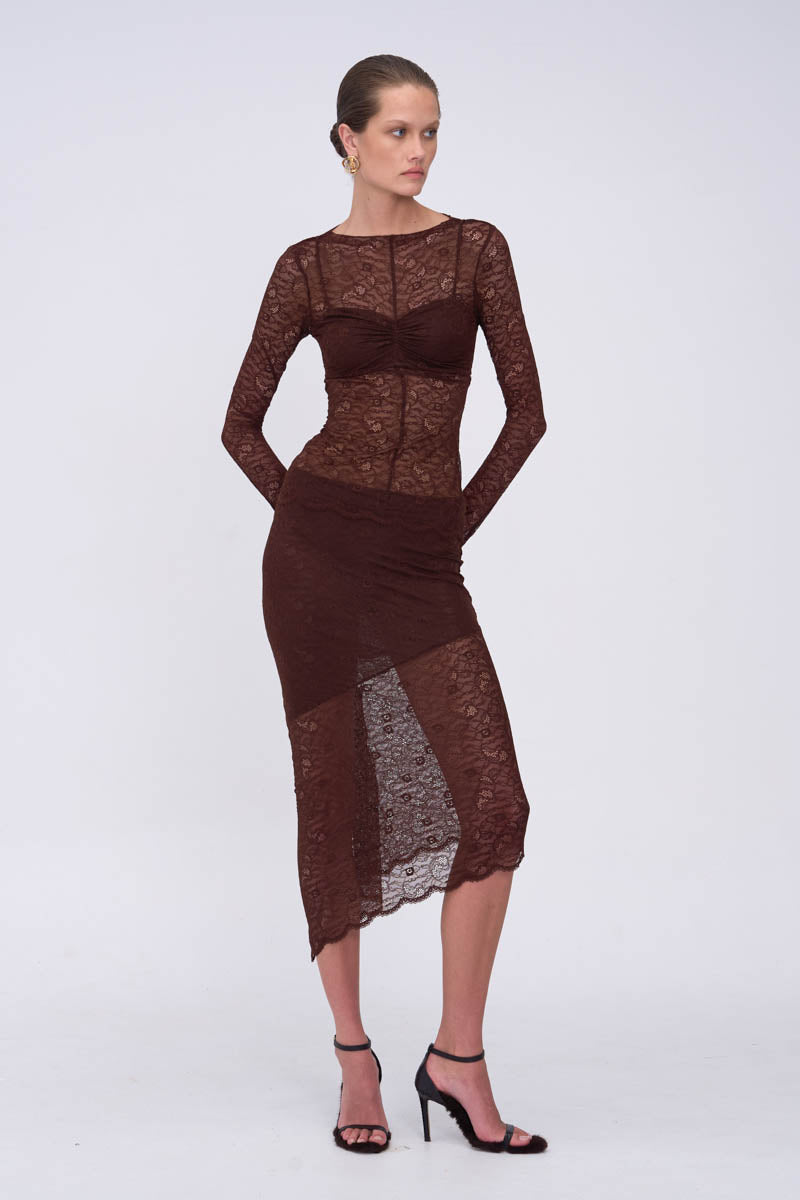 Woman wearing a matching dark brown lace long sleeve top & skirt 