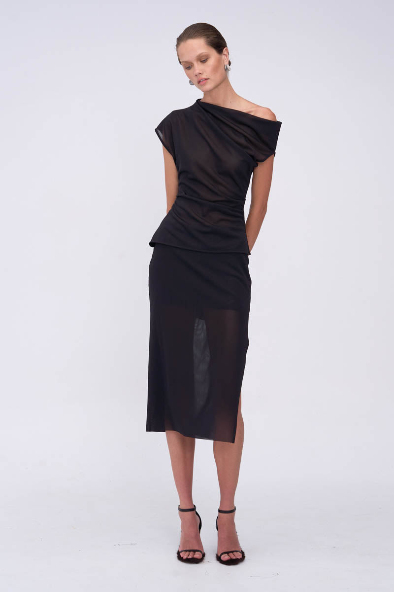 Woman wearing a black one-shoulder top with matching skirt