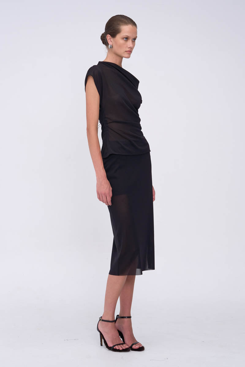 Woman wearing a black one-shoulder top with matching skirt
